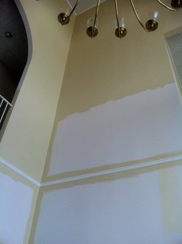Two-story foyer wall partly primed white