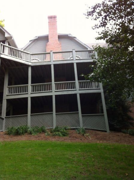 Back of a gray house with three stacked porches