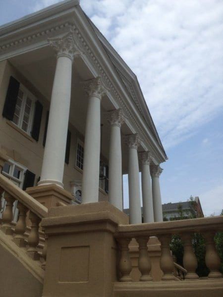 Front porch with tall white columns and a balustrade