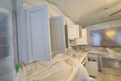 Interior kitchen cabinet painting  preparation and covering by The Painting Group and Renovation
